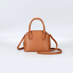 Stylish brown dome handbag for women, featuring textured leather, top handles and cross-body strap.