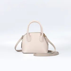 Elegant beige dome handbag with top handles and adjustable crossbody strap for daily casual wear.