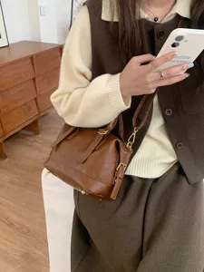 Retro brown PU leather bowling bag detail, chic women's shoulder pillow handbag.