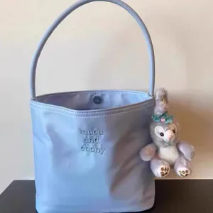 Korean style nylon underarm bag, cute embroidered lavender handbag with plush keychain detail.