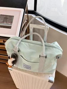 Large capacity travel duffel bag with trolley sleeve, lightweight waterproof gym bag for women.