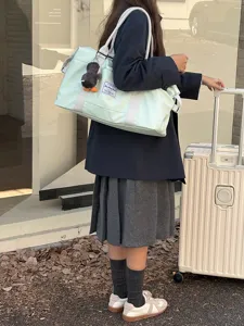 Detailed view of the large capacity travel duffel bag with trolley sleeve in use.