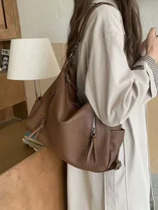 Vintage brown leather shoulder bag for women, large capacity underarm hobo bag for daily commute.