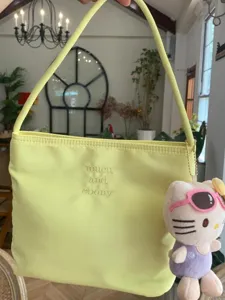Minimalist nylon shoulder bag for women, trendy underarm handbag with chic embroidery design.