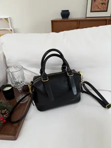 Black bowling bag for women, retro shoulder bag, stylish commuter pillow bag, versatile handbag.