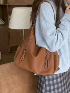 Brown leather shoulder bag for women, vintage slouchy hobo tote with zipper pockets.