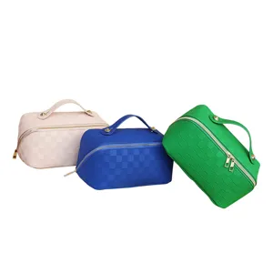 Large capacity PU leather cosmetic bag with top handle and stylish grid pattern for travel.