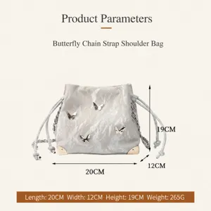 Silver bucket bag with 3D butterflies, metal chain strap and drawstring. Size: 20x12x19cm.