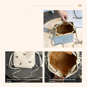 Silver bucket bag with metal chain strap, drawstring closure and butterfly decor for daily use.