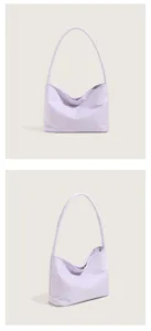Detailed view of light purple nylon underarm bag with smooth fabric and subtle front embroidery.