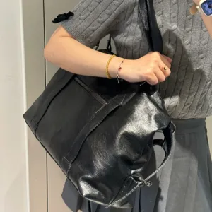 Vintage black soft leather tote bag for women, large capacity casual travel and commute shoulder bag.