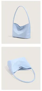 Minimalist light blue nylon shoulder underarm bag for women, lightweight casual commuter bag.