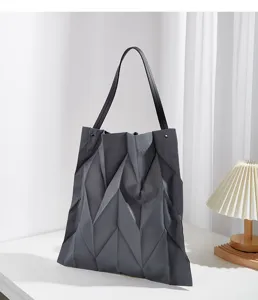 Detailed view of the dark grey geometric pleated canvas tote bag, stylish and spacious shoulder bag.
