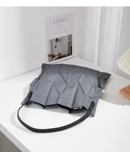 Grey geometric pleated canvas shoulder bag detail view, casual tote for women and students.