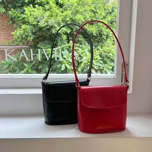 Detail shot of retro glossy bucket bag, PU leather small square handbag, minimalist style.
