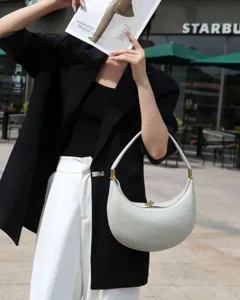 Stylish white leather crescent hobo shoulder bag for women, chic commuting handbag and purse.