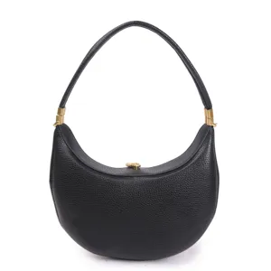 Detail view of black crescent hobo shoulder bag with pebble leather and gold hardware.