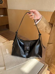 Vintage black PU leather shoulder bag, retro underarm style, chic commuting handbag.