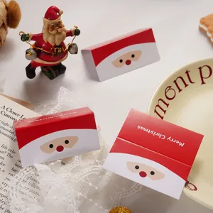 Detailed view of Christmas packaging header cards with cute Santa Claus face design for holiday decor.