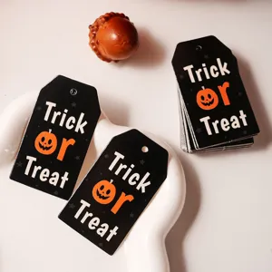 Halloween gift tags close up view, black paper hanging tag with cute pumpkin graphic.
