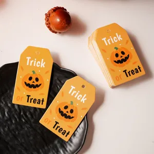 Detailed view of Halloween paper tags featuring cute pumpkin designs for gift decoration.