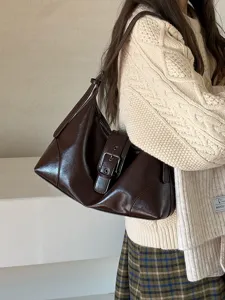 Vintage brown leather underarm shoulder bag for women, chic retro daily commuting handbag.