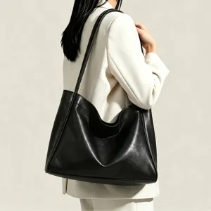 Minimalist black soft leather tote bag for women, large capacity casual commute shoulder bag.