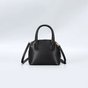 Classic black dome handbag featuring textured leather and gold hardware, ideal for daily chic style.