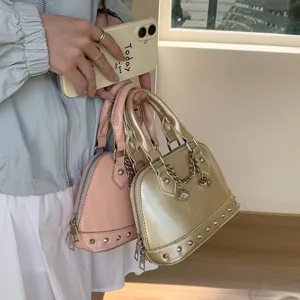 Stylish patent leather shell handbag with chic rivet and dice chain for women fashion.