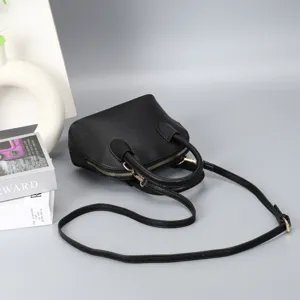 Black dome handbag with top handles and adjustable shoulder strap for women detail view