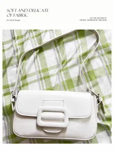 White stylish solid color underarm shoulder bag with chic buckle, versatile fashion accessory.