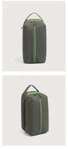 Detailed view of dark grey pu cosmetic pouch featuring vibrant green zippers and top carry handle.