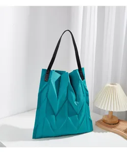 Detailed view of the turquoise pleated canvas shoulder tote bag, ideal for daily commute.