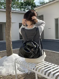 Detailed view of the black soft leather hobo shoulder bag showing metal hardware.