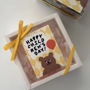 Quadratische Geschenkverpackung mit Bären-Design und gelbem Band für Kinderfest