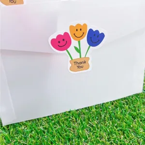 Detailaufnahme bunter Tulpen Smiley Dankeschön Siegelaufkleber auf Verpackungsumschlag.