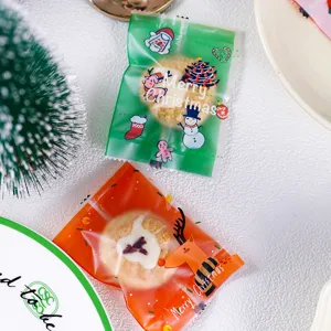 Christmas frosted cookie packaging bag with cute Santa and reindeer, holiday gift wrap.