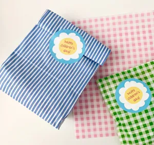 Children day decorative stickers set with colorful striped and checkered gift paper bags.