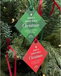 Christmas gift tags detail shot, diamond shape red and green cards hanging on tree.