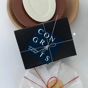 Minimalist graduation greeting card set with gift box and elegant message card for students.