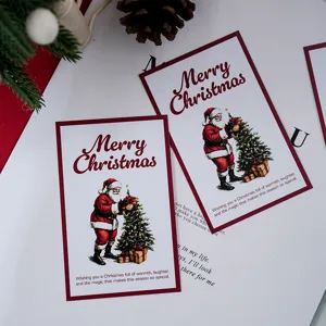 Detailed view of vintage Santa Claus Christmas cards with festive greetings and gift wrapping decor.