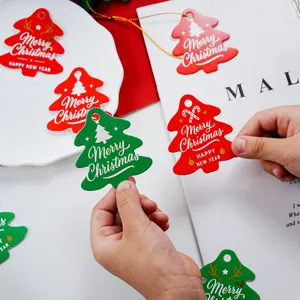 Christmas tree gift tags detail view, festive red green paper tags for DIY holiday party decor.
