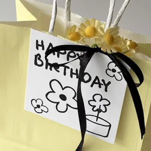 INS style happy birthday greeting card gift tag with black ribbon and floral decoration.