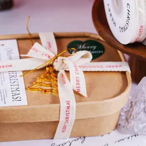 Christmas ribbon detail shot showing gift packaging ribbon with merry christmas print for festive decor.