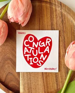 Detail view of a square birthday greeting card with heart design and warm wishes.