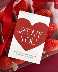 Close-up detail of romantic Valentine greeting card with red heart and love you quote.
