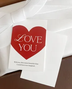 Detailed close-up of a romantic red heart greeting card with love text inside a gift box.