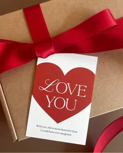 Close-up detail shot of a romantic Valentine's greeting card with red heart and love quote.