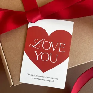 Valentine day greeting card with red heart design and elegant gift box ribbon packing.