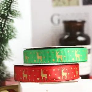 Christmas gift wrapping ribbon, 1.6cm wide red and green satin ribbon with gold reindeer.